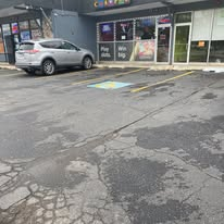 Worn commercial parking lot before paving